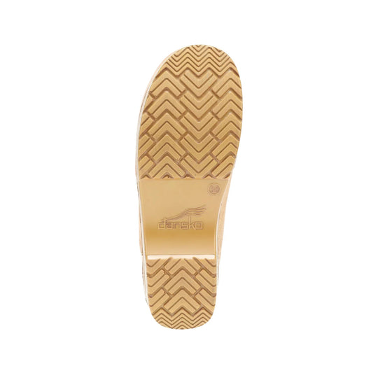 Tan rubber boot sole with chevron tread and Dansko logo