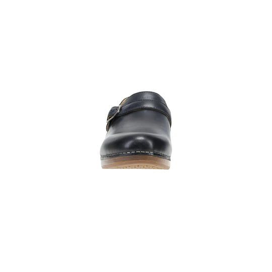 Black leather clog seen from the front with a buckle strap and tan sole