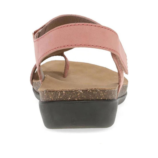 Pink leather sandal viewed from the back with a cork midsole and black wedge heel