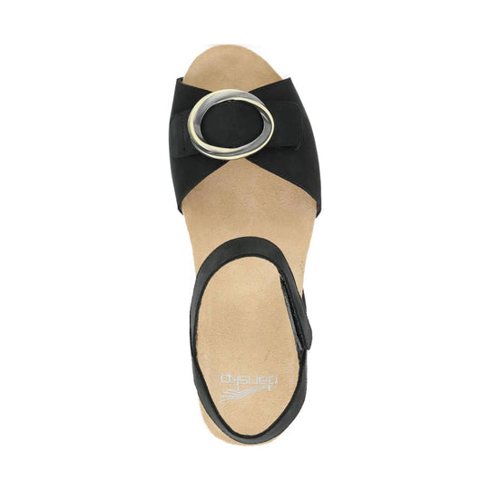 Black open-toe slingback sandal with a large oval buckle strap and suede footbed