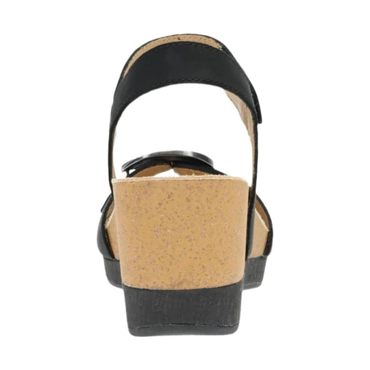 Black slingback sandal with cork wedge heel and wide ankle strap, rear view