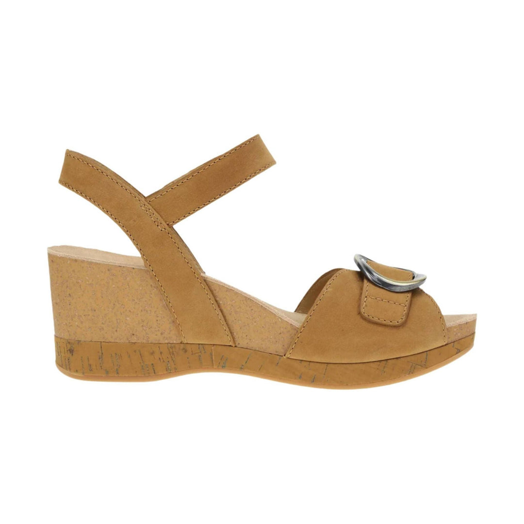Tan wedge sandal with crossed ankle straps, open toe, and a silver buckle