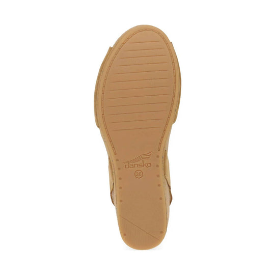 Tan sandal outsole with Dansko logo and size 38 marked on the heel