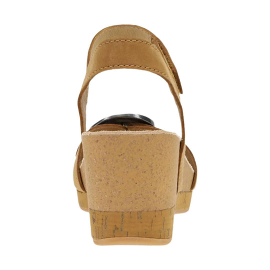 Tan wedge sandal viewed from the back with a cork-look heel and ankle strap