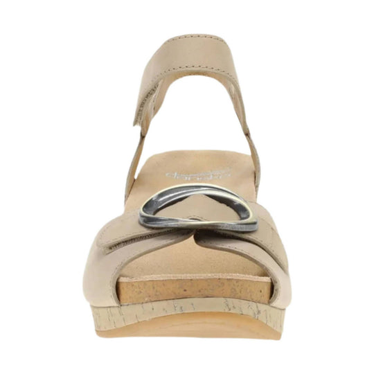 Beige platform sandal with a wide toe strap, metal ring detail, and cork wedge heel
