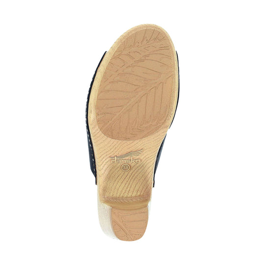 Tan shoe outsole with leaf-pattern tread and Dansko size 38 marking
