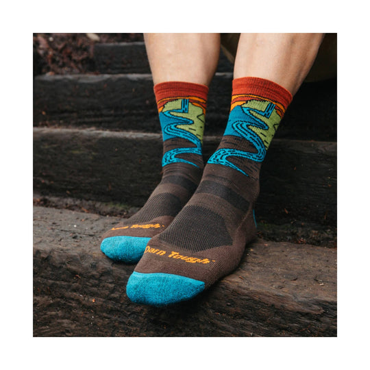 Brown hiking socks with bright blue toes and multicolor waterfall pattern on the calves