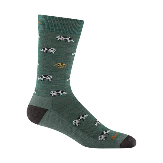 Green crew sock with cow pattern and orange visible text on the foot
