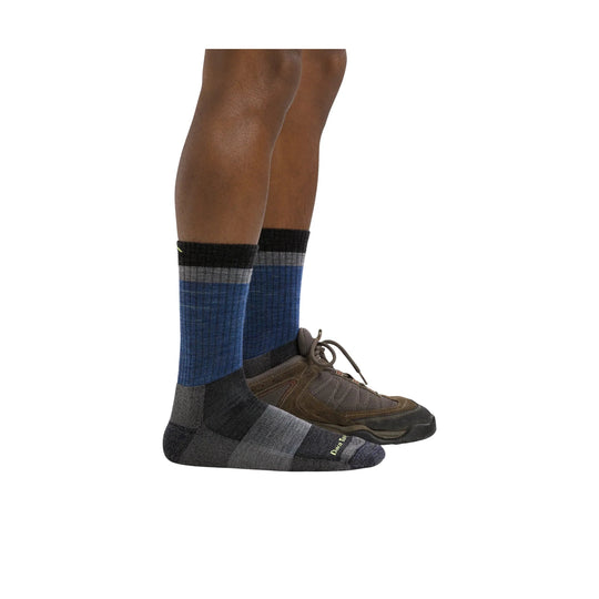 Blue and gray striped crew hiking socks on a person wearing trail shoes