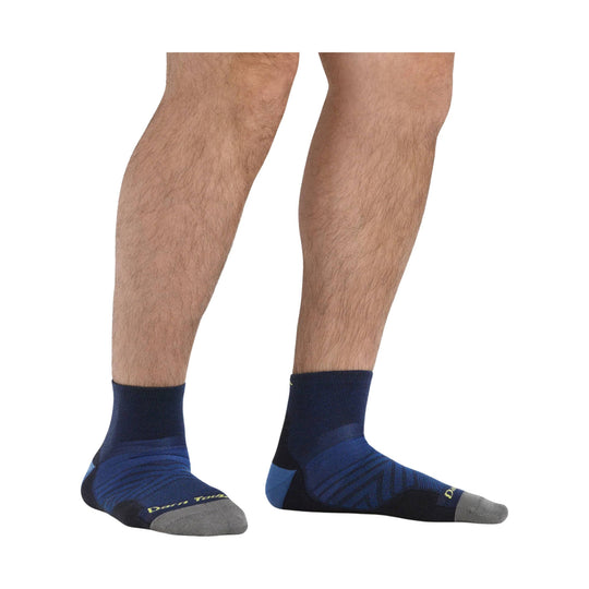 Navy and blue ankle running sock with gray toe and heel on a model's feet