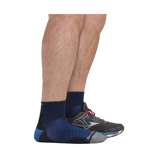 Navy and blue quarter running socks worn with gray running shoes