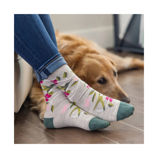 Floral crew sock with teal toe and heel worn with jeans