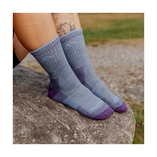 Gray crew hiking socks with purple toe and heel accents worn on feet outdoors