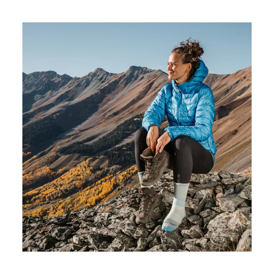 Two brown hiking boots with heavyweight crew socks