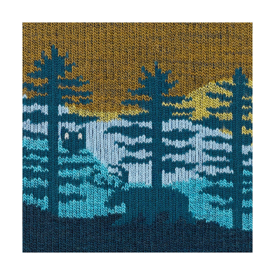 Dark teal knit sock with tan, blue, and white mountain-and-trees pattern