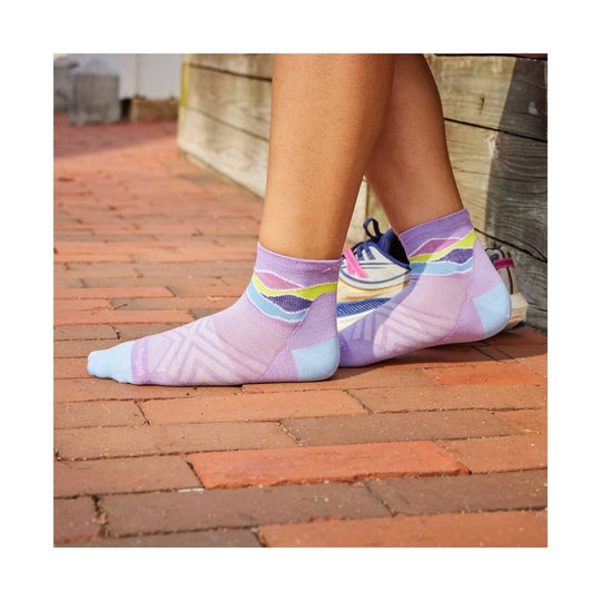 Lavender ankle running socks with pastel blue toes and rainbow stripe bands, worn with sneakers