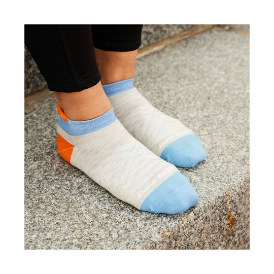 White ankle running socks with light blue toes and cuffs and an orange heel accent