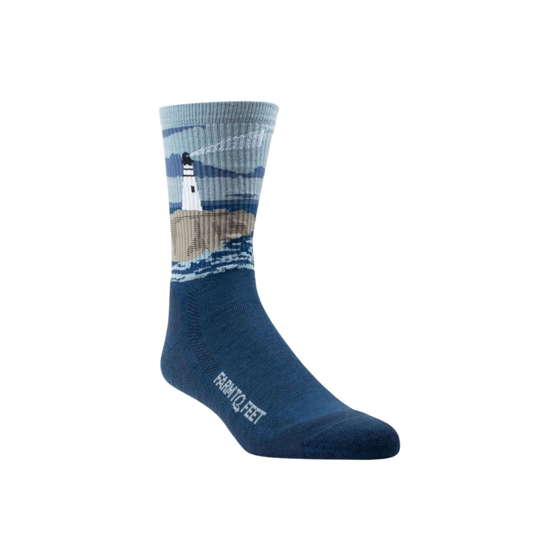 Blue crew sock with lighthouse and shoreline pattern, with "FARM TO FEET" text on the foot.
