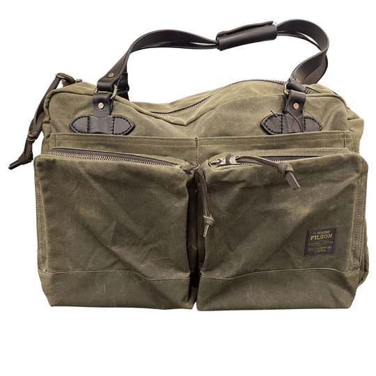 Olive canvas duffel bag with brown leather handles, front pockets, and a Filson label