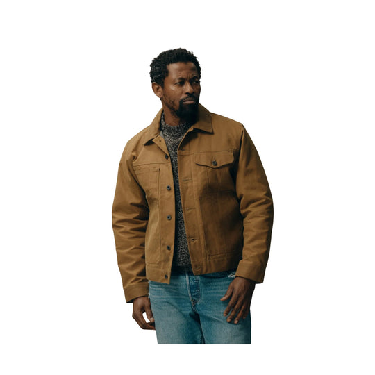 Brown button-front jacket over a gray knit sweater and blue jeans