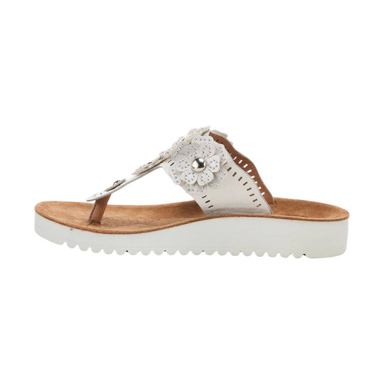 White thong sandal with floral rhinestone embellishment and a tan footbed on a white wedge sole