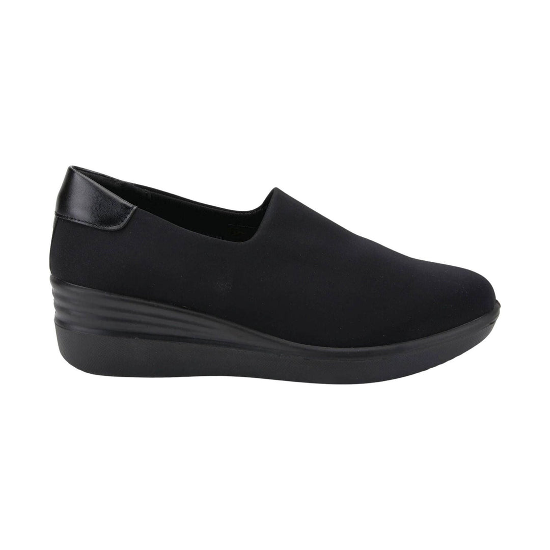 Black slip-on wedge sneaker with a smooth upper and textured platform sole