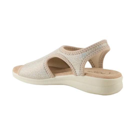 Beige wedge sandal with sparkly upper, side cutouts, and a cushioned cork footbed