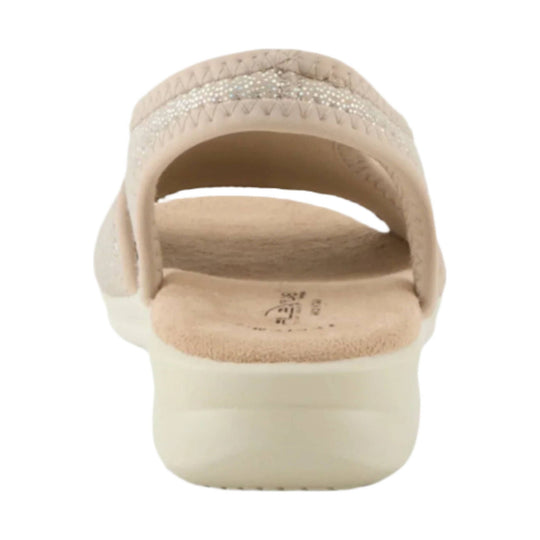 Beige slip-on sandal viewed from the back, with a wide strap, rhinestone detail, and thick cushioned sole