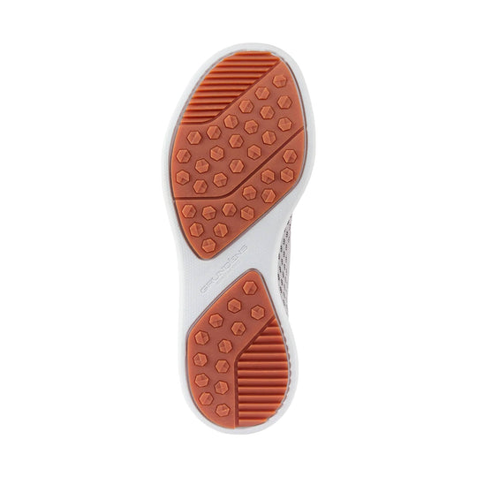 White boat shoe outsole with orange rubber tread pods and ribbed traction panels