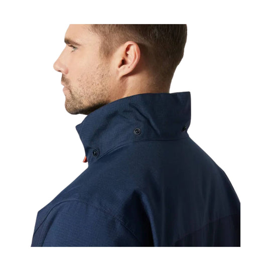 Navy insulated jacket shown in side profile with a high collar and snap details