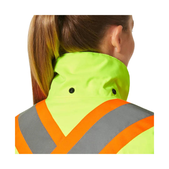 Neon yellow hi-vis winter jacket with orange and gray reflective chevrons, shown from the back with raised collar