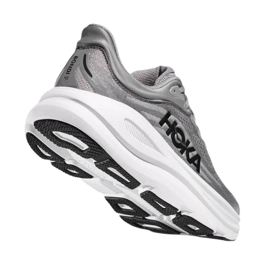 Gray HOKA running shoe shown from the side and sole, with black outsole details
