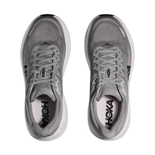 Gray running shoes shown from above with HOKA logos on the tongue and insole