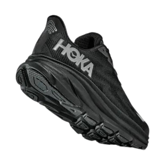 Black athletic running shoe with a knit upper and thick lugged sole, shown from the side and bottom.