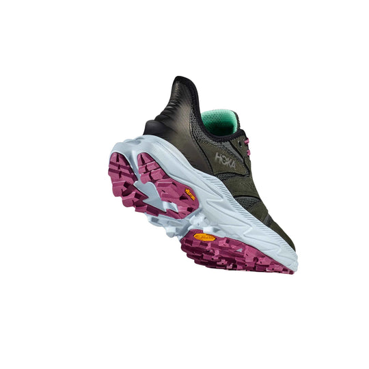 Low hiking shoe with a black upper, green lining, and white sole with magenta tread