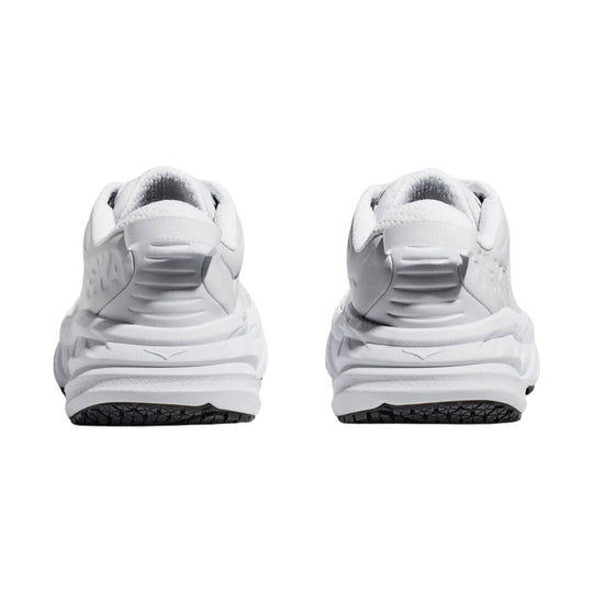 White athletic sneakers shown from the back with thick cushioned midsoles and black outsoles