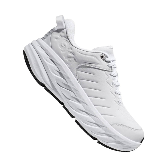 White low-top athletic shoe with thick textured sole and black outsole