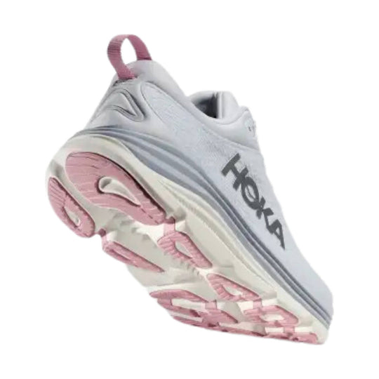 White running shoe with pink outsole and gray HOKA logo, shown from below