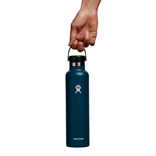 Dark blue reusable water bottle with a black cap and carrying loop, shown held upright by a hand