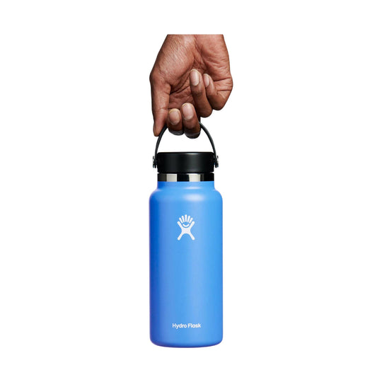Blue insulated water bottle with black lid and carry handle, featuring a white logo and visible Hydro Flask text