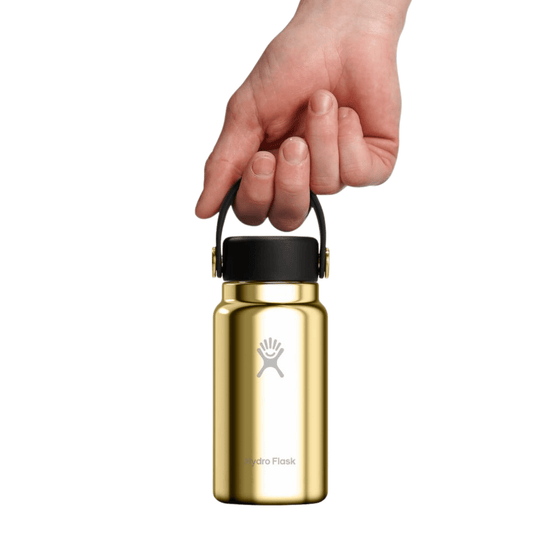 Gold insulated water bottle with black cap and carry loop