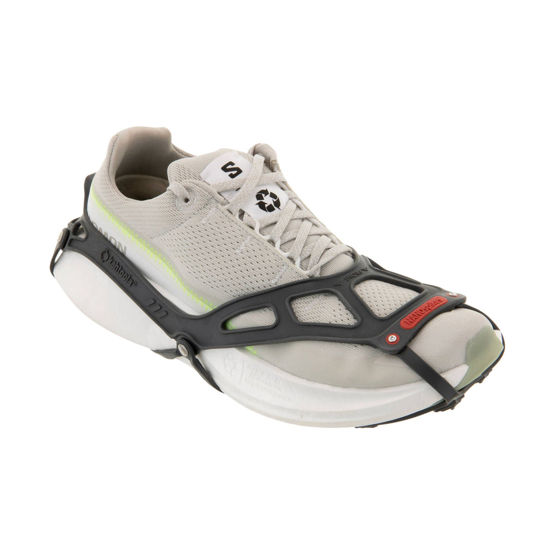 Light gray trail shoe with a black traction frame and laces, shown in side view.