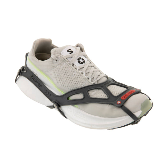 Light gray trail shoe with a black traction frame and laces, shown in side view.