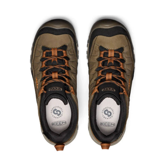 Pair of brown and black hiking shoes with orange laces, top view