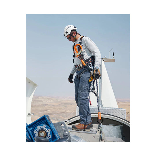 Brown and black lace-up work boots worn by a worker on a wind turbine