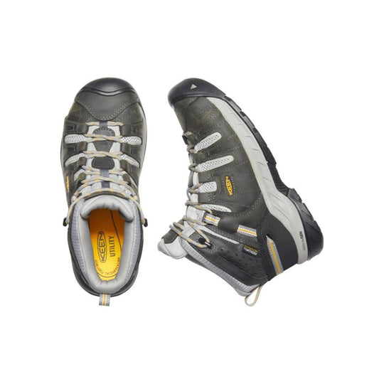 Pair of gray and black mid-height utility boots with white laces and rubber toe caps