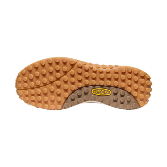 Tan and gray rubber shoe sole with round lugs and a KEEN logo