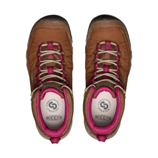 Pair of brown hiking boots with pink collars, viewed from above
