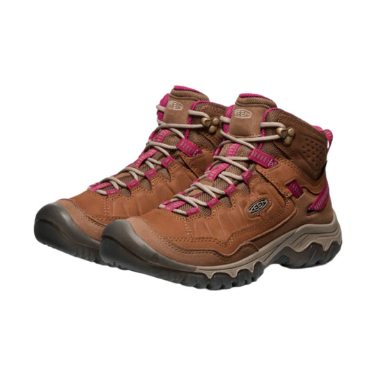 Brown mid hiking boots with pink accents, black rubber toes, and KEEN logos