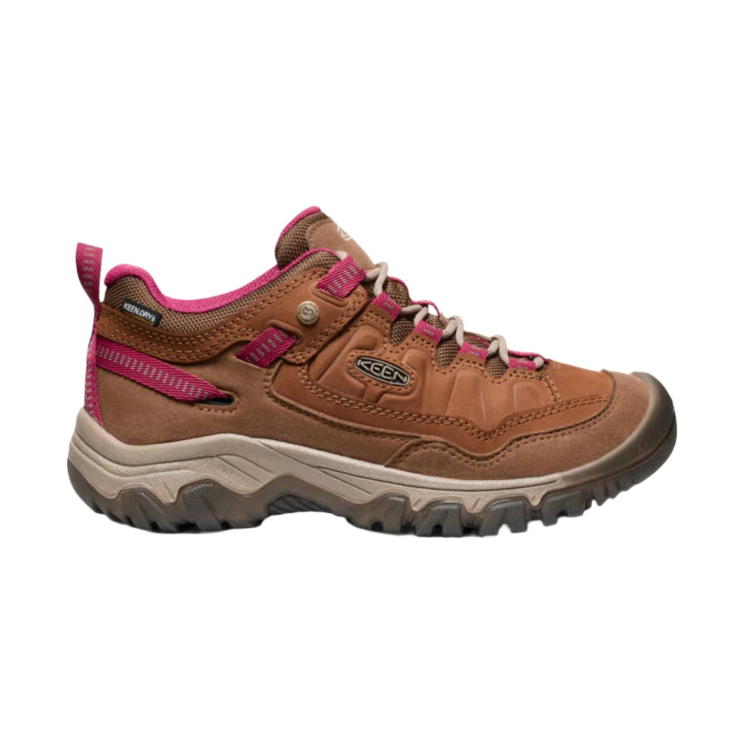 Brown low-top hiking shoe with pink trim, tan laces, and rugged tread, shown in side profile